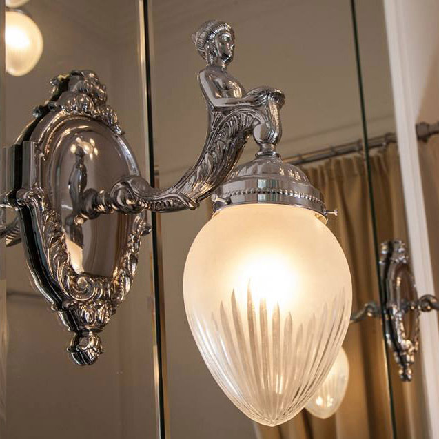 Barock-Wandleuchte mit figürlicher Skulptur und spitzem Glas: Barocke Wandleuchte in glänzend vernickelt, hier mit Glas-Dekorschliff 2 „Stern“