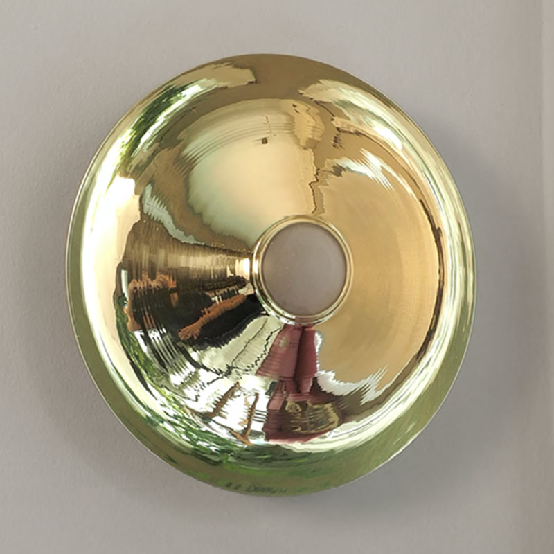 Wall light made of brass disc and glass ball