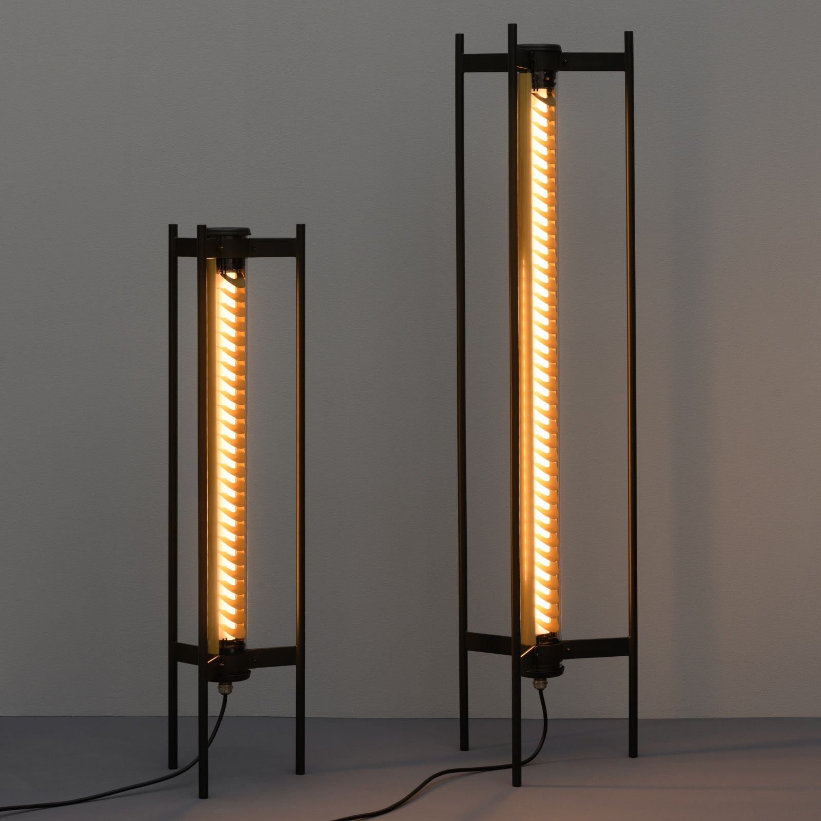 Fig. 1: The small and large model with brass-coloured lamella reflector Unique Tubular Design Floor Lamp ELGAR FLOOR: The small and large model with brass-coloured lamella reflector